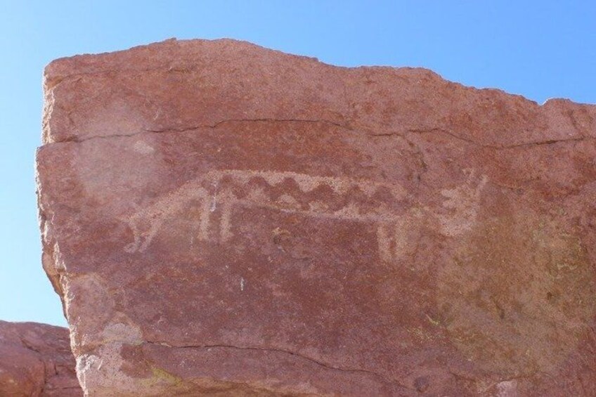 A large red rock with ancient petroglyphs. 2