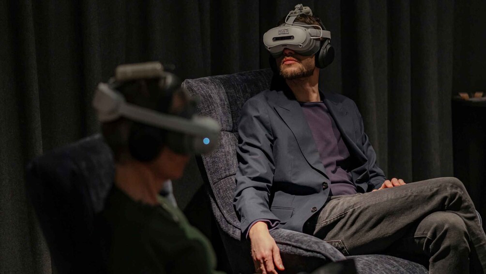 A person wearing a VR headset seated in a chair. 1