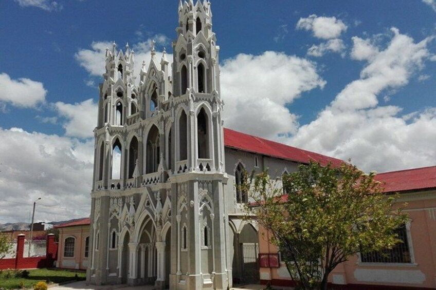 A Gothic-style church with a red roof and intricate architecture. 4