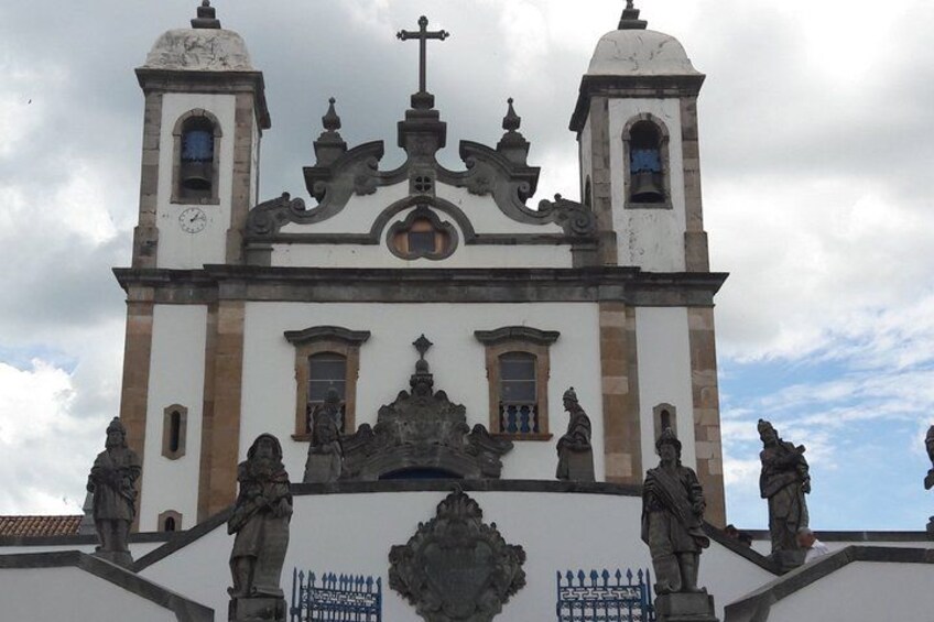 A historic church with two bell towers, ornate facade, and statues. 1