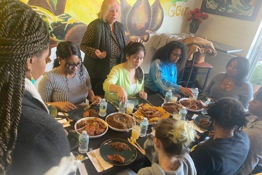A group of people dining at a restaurant with various dishes on the table. 1