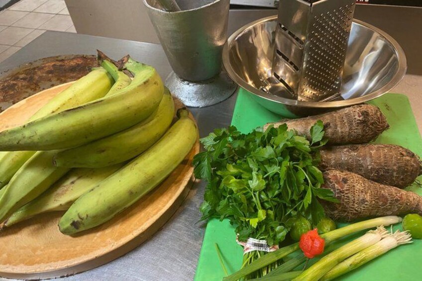 Bananas, parsley, leeks, and a metal grater on a kitchen counter. 5