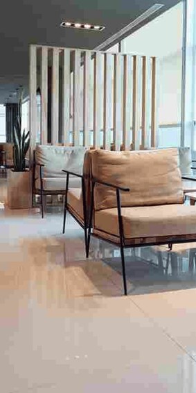 A modern interior with a sofa, chairs, and a decorative wooden panel. 3
