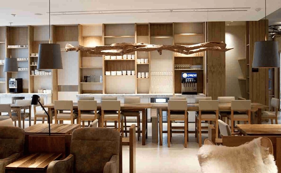 A modern interior with wooden furniture, a central table, and shelves with products. 4