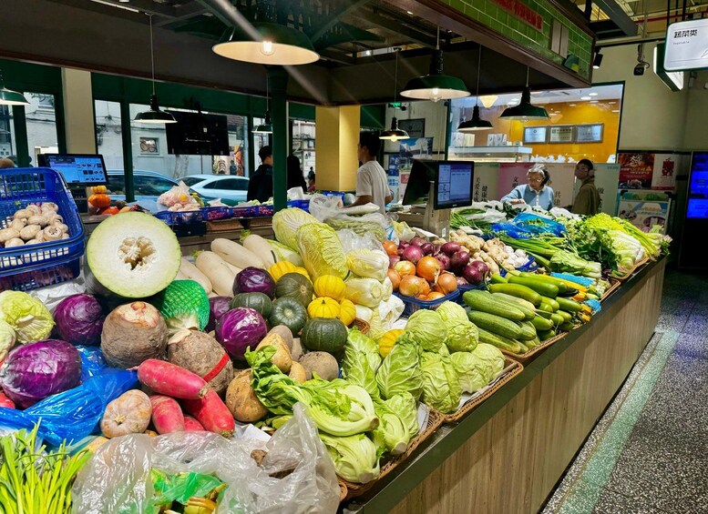 A grocery store's produce section with various vegetables and fruits. 3