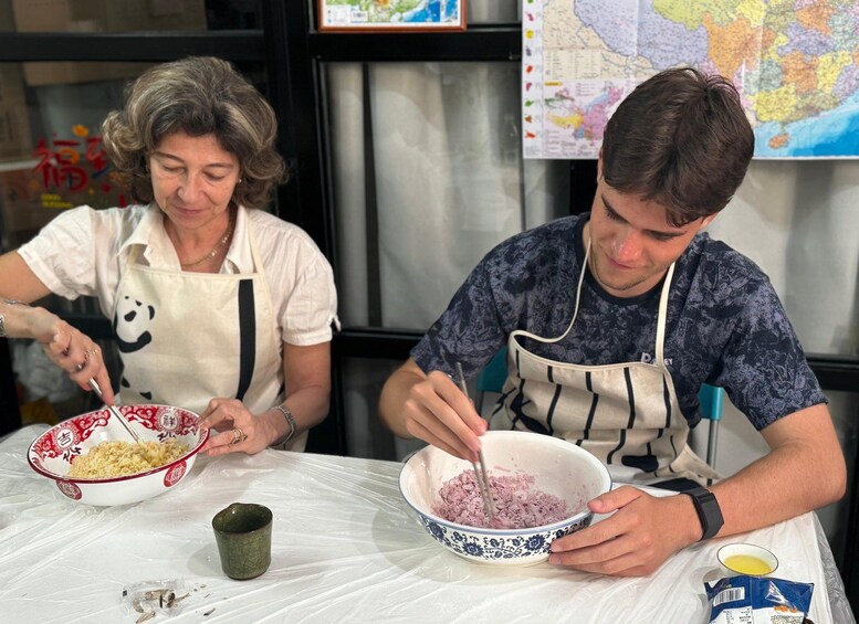 Two people preparing food, one stirring a bowl and the other holding a spoon. 2
