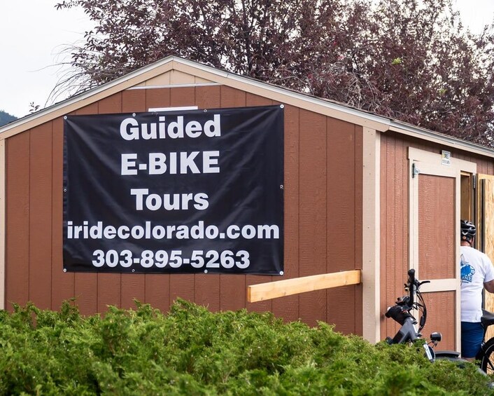 A building with a banner advertising guided e-bike tours. 3