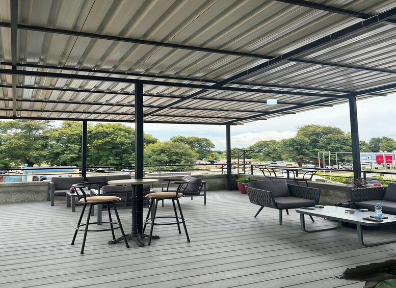An outdoor patio with seating and a view of the surrounding area. 5