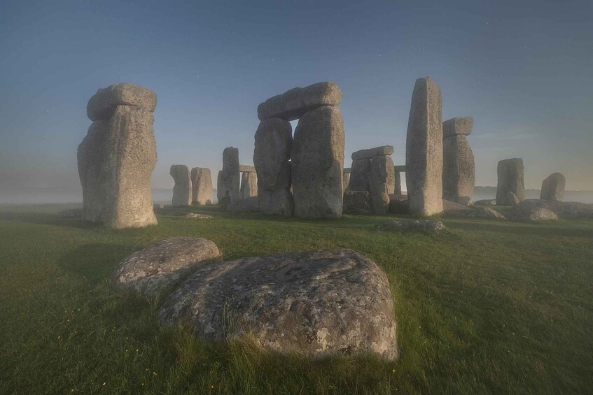 Stonehenge standing in a grassy field. 3