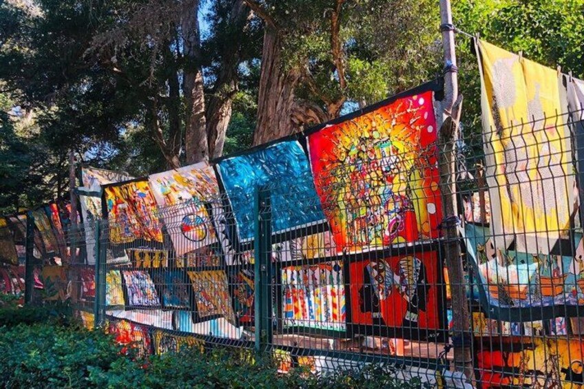 A fence with colorful artwork. 5