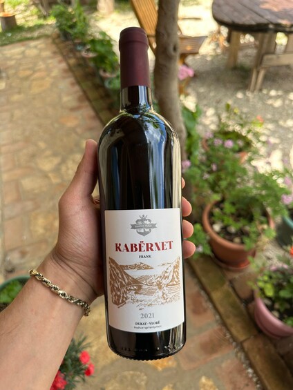 A hand holding a wine bottle with a label that reads 'KABERNET FRANK 2021 DUKAT - VLORE.' 2