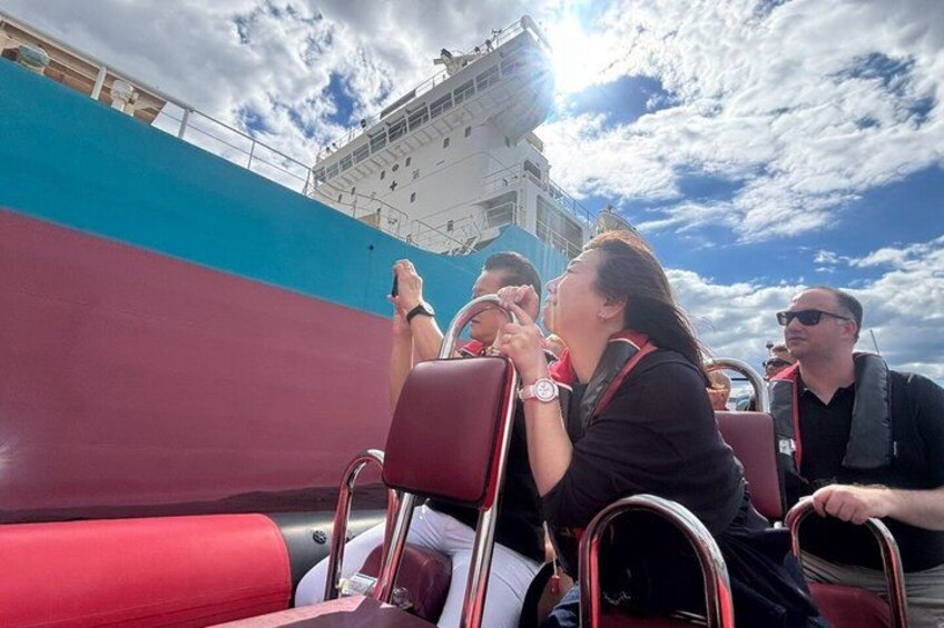 Passengers on a cruise ship deck, looking out at the ocean. 5