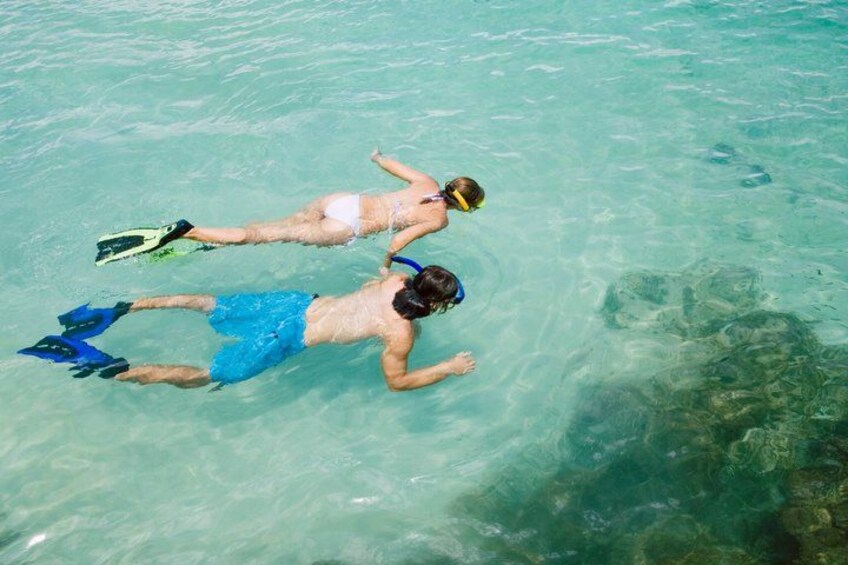Two people snorkeling in clear water. 2