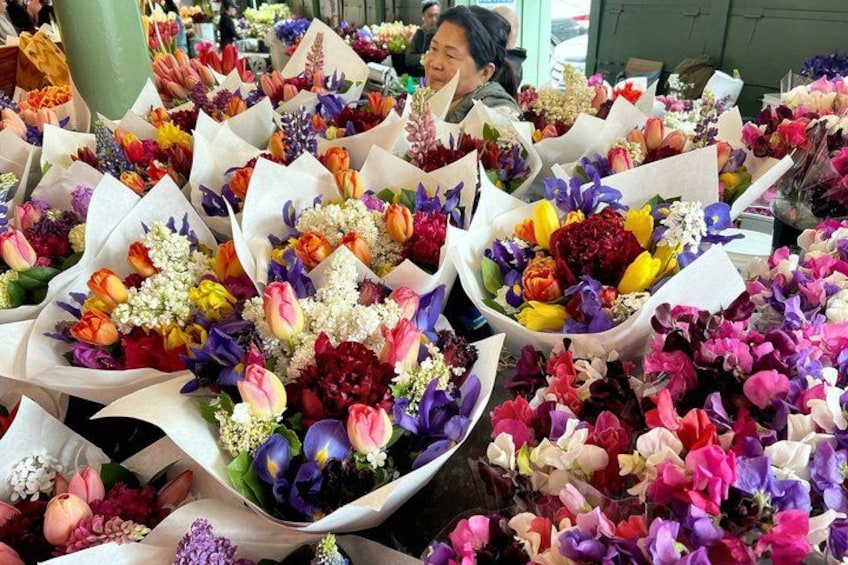 A market with various bouquets of flowers. 3