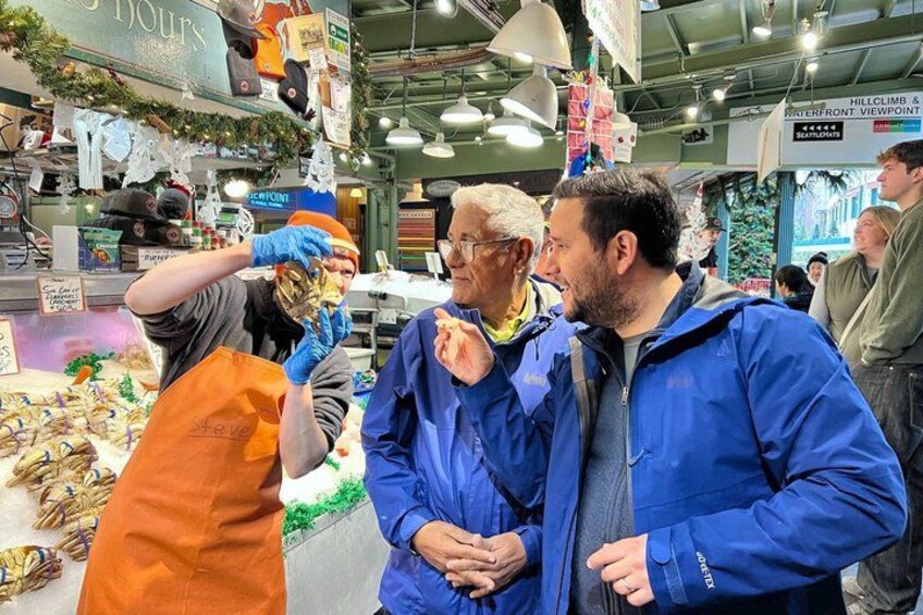 A market with people shopping and a vendor serving food. 5
