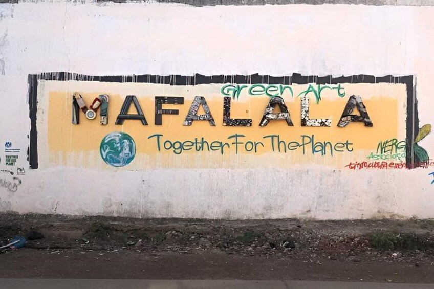 A wall with graffiti art, including the words 'green art' and 'Together for the Planet.' 1