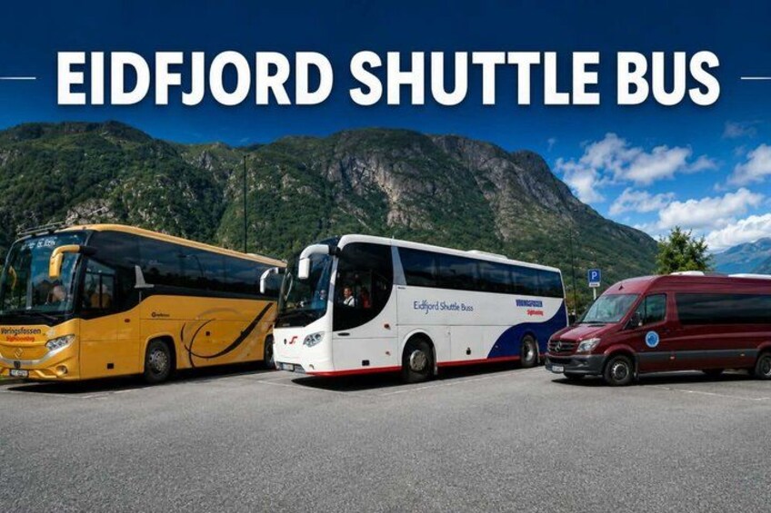 Three shuttle buses parked in a line with a mountainous landscape in the background. 2