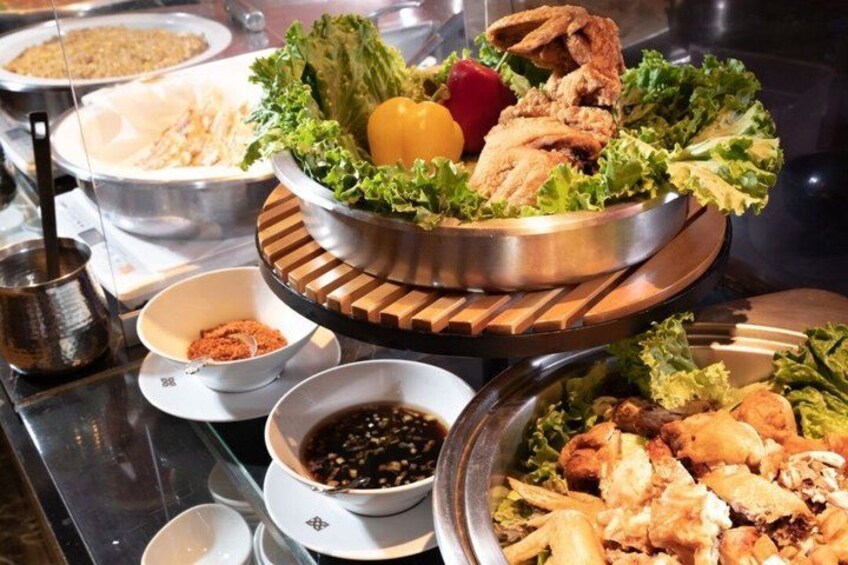 A buffet with various dishes, including fried chicken and vegetables. 4