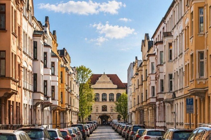 A street lined with parked cars and historic buildings. 5