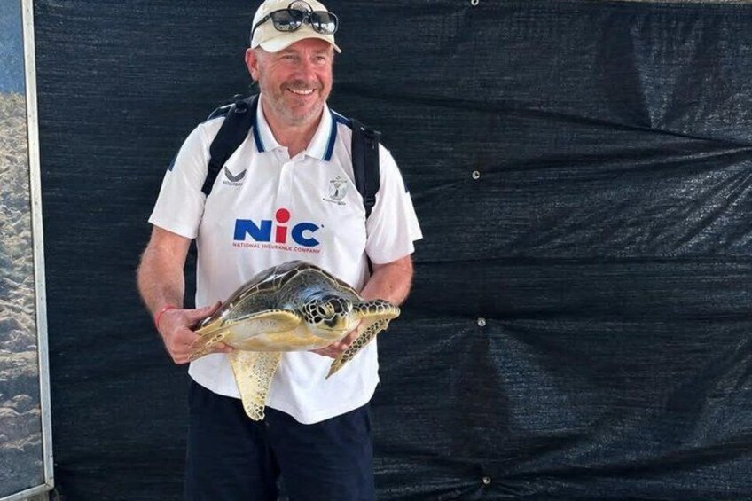 A person holding a turtle. 3