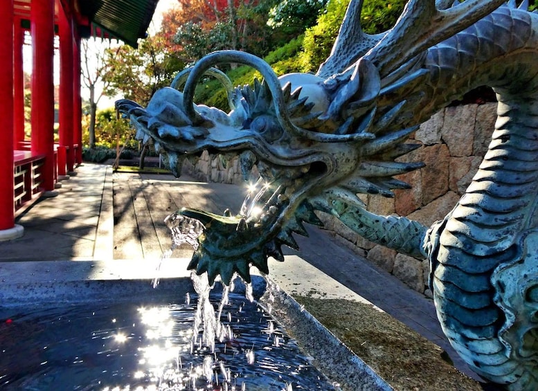 A dragon sculpture with water flowing from its mouth. 5