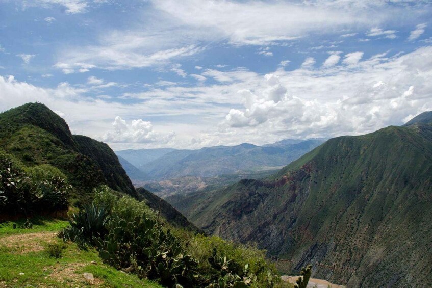 A mountainous landscape with lush greenery and a valley. 3
