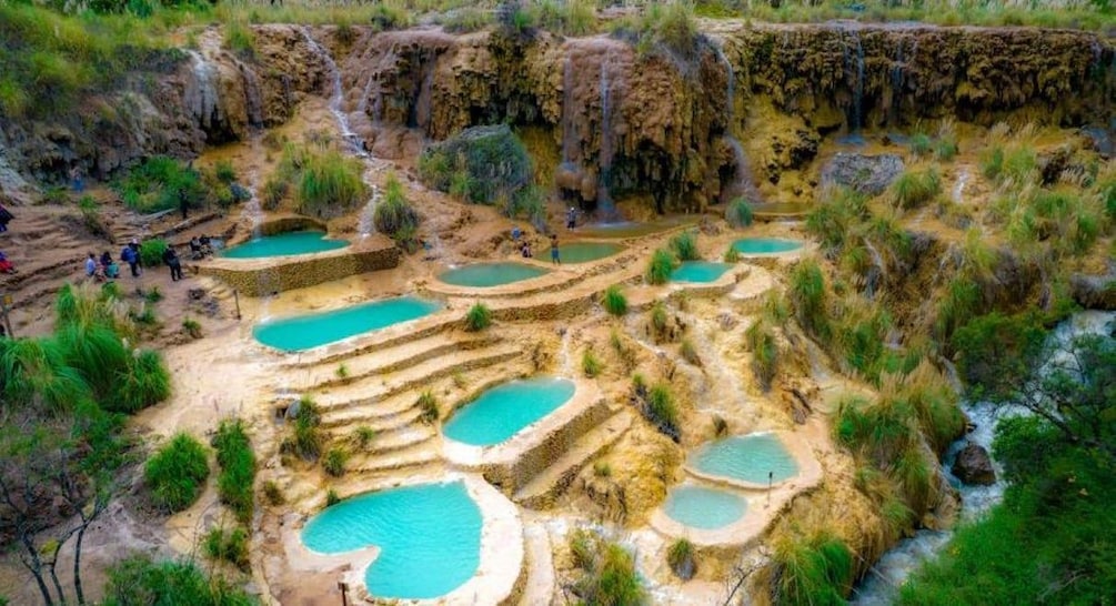 Terraced pools with waterfalls in a natural landscape. 1