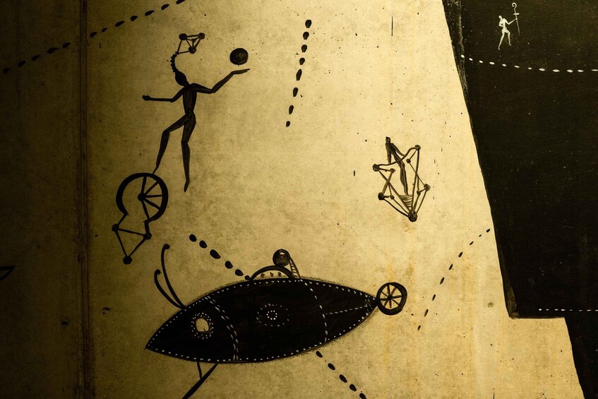 A drawing of a person on a unicycle, a UFO, and a person walking with a staff. 2