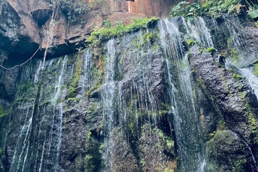 A waterfall cascading down a rocky cliff. 3