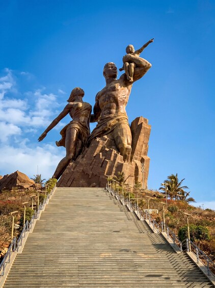 A large stone statue of a man and a woman on a staircase. 3