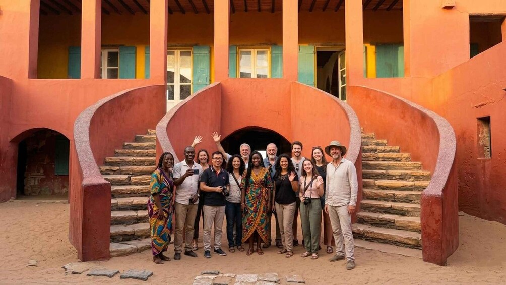 A group of people standing in front of a building with a staircase. 1