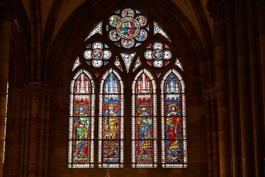 A stained glass window with intricate designs and figures. 2