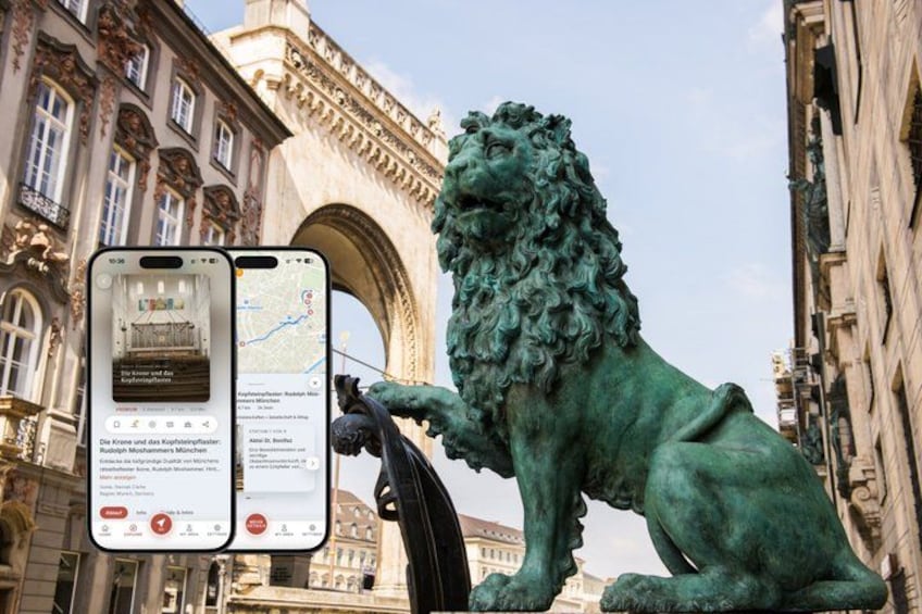 A bronze lion statue in an urban setting with classical architecture in the background. 1