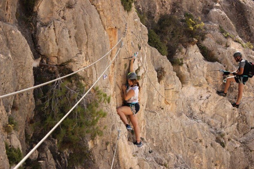 A person rock climbing on a rocky cliff. 5