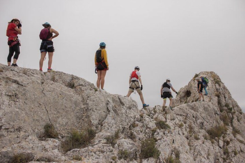 A group of hikers on a rocky mountain peak. 3