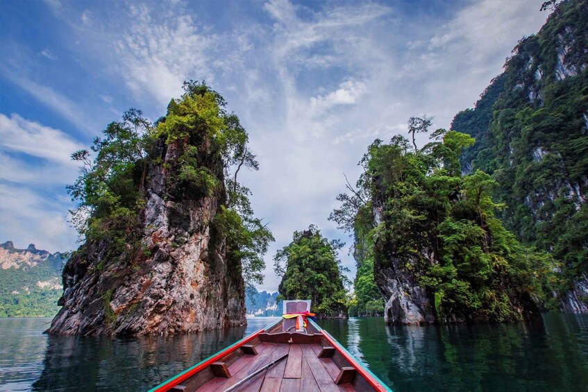 A boat on a calm river surrounded by lush green islands. 4