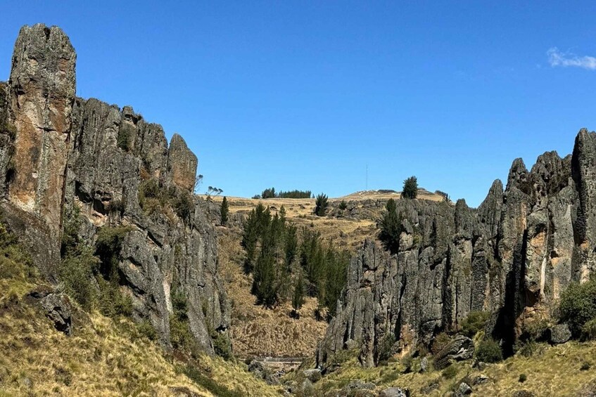 A rugged landscape with prominent rock formations and sparse vegetation. 5