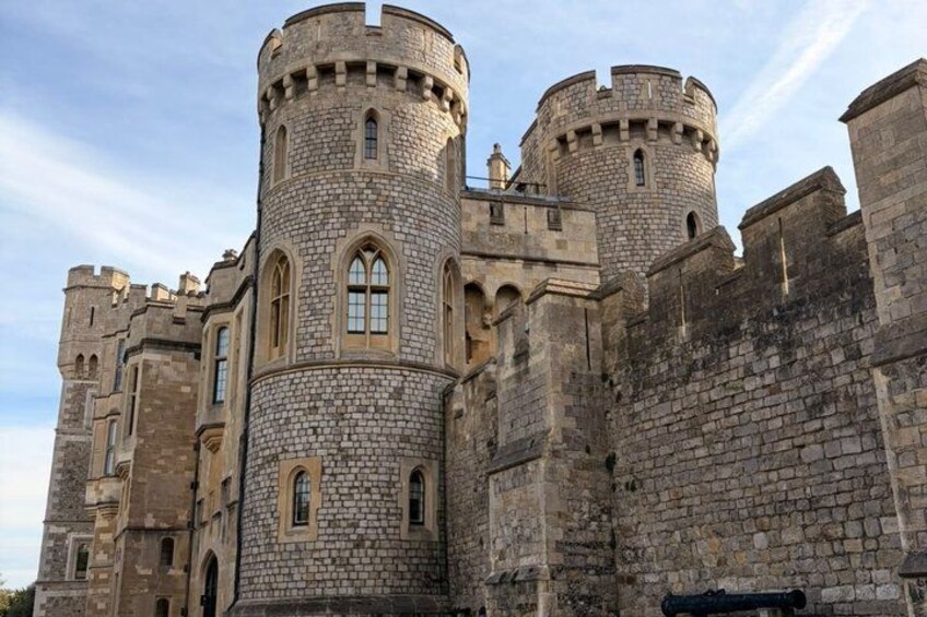 A medieval castle with stone walls, arched windows, and round towers. 3