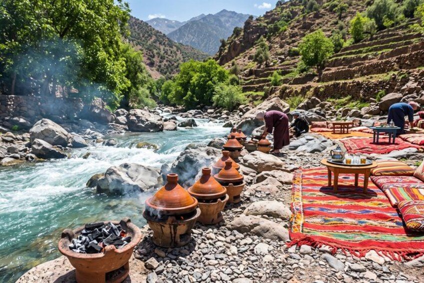 A river with rocks, terracotta pots, and a colorful blanket. 3