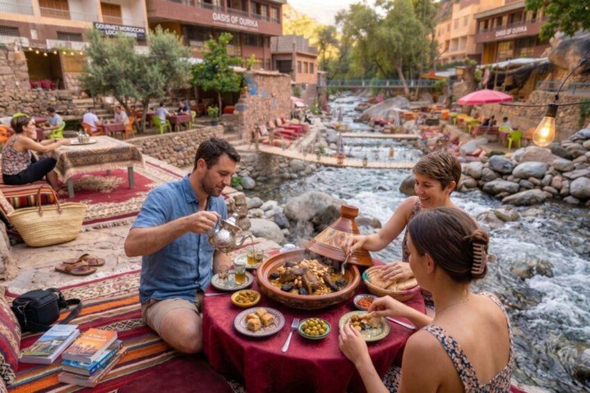 A riverside dining setting with people enjoying a meal. 1