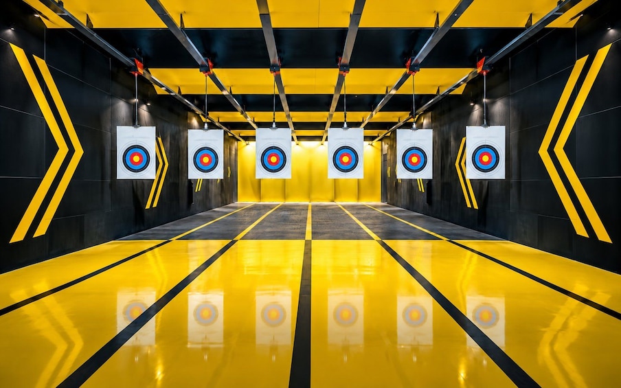 A shooting range with targets and yellow and black walls. 5