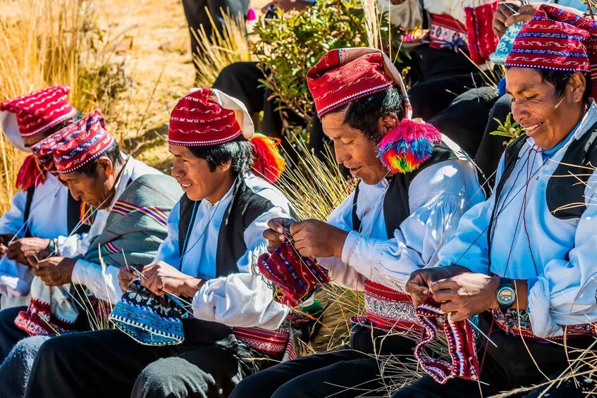 People engaged in traditional weaving, wearing colorful garments and hats. 4