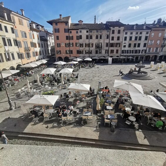 A plaza with outdoor seating and a fountain. 3
