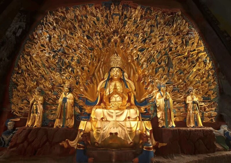 A golden statue with multiple figures in a temple setting. 1