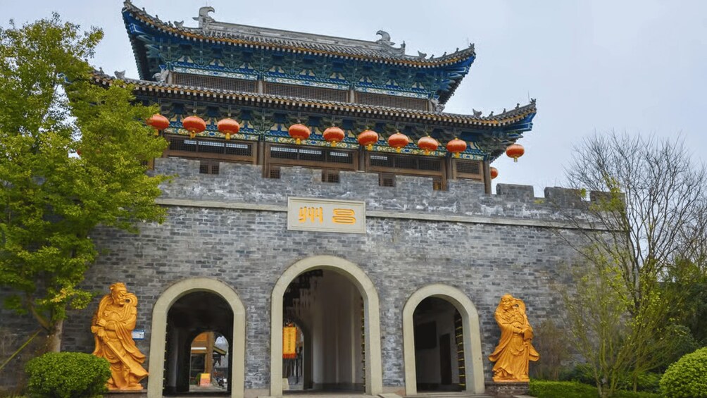 A traditional Chinese building with ornate architecture, including a tiled roof and red lanterns. 2