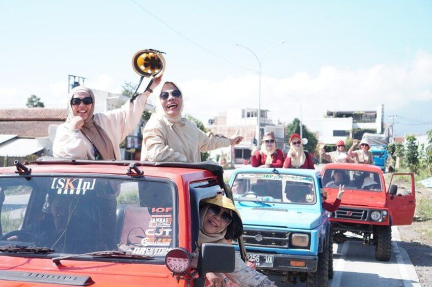 A group of people in a line of vehicles on a road. 1