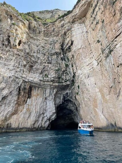 A boat navigating through a narrow canyon with steep rock walls. 3