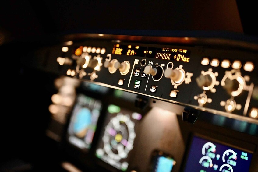 A cockpit control panel with various dials, switches, and digital displays. 4