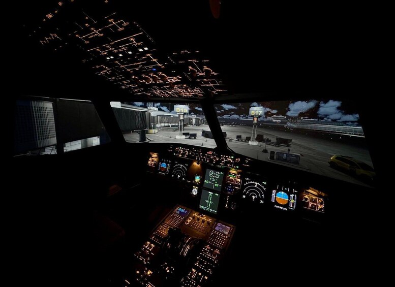 The cockpit of an aircraft with multiple control panels and a view of the airport runway. 2