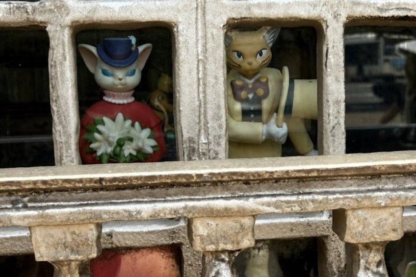Two figurines in a window. 1